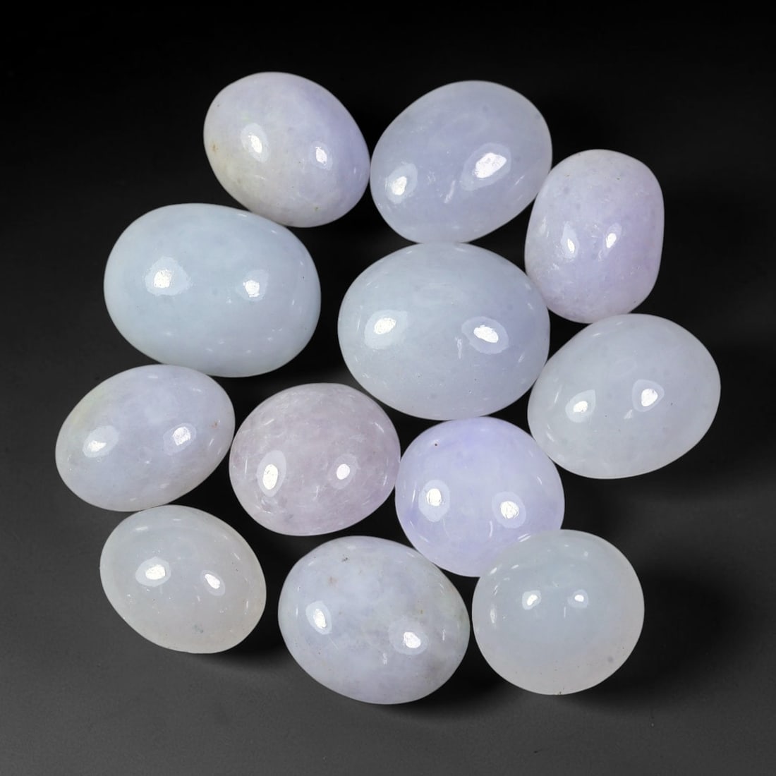 75.95ct Natural Burmese Type A Lavender Jadeite Jade Cabochon Parcel Lot, 37EX: This polished cabochon parcel features oval and round cabochon Type A jadeite jade displaying soft lavender-lilac body tones across the set. Smooth high-gloss domed surfaces showcase gentle colour var