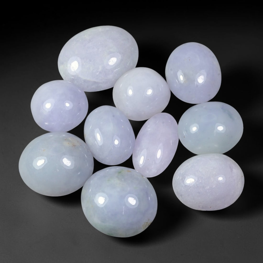 76.19ct Natural Burmese Type A Lavender Jadeite Jade Cabochon Parcel Lot, 36EX: This polished cabochon parcel features oval and round cabochon Type A jadeite jade displaying soft lavender-lilac body tones across the set. Smooth high-gloss domed surfaces showcase gentle colour var