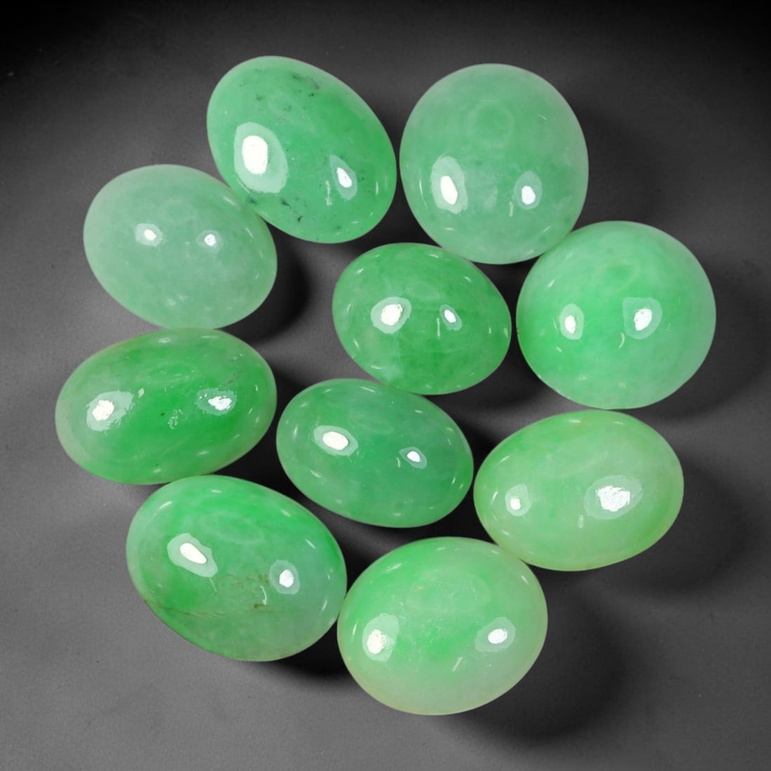 36.05ct Natural Burmese Type A Jadeite Jade Cabochon Parcel Lot, 42EX: This oval cabochon parcel consists of polished Type A jadeite cabochons showing soft pastel to medium lively green colour shades across smooth domed surfaces. Glossy polished finishes reveal natural i