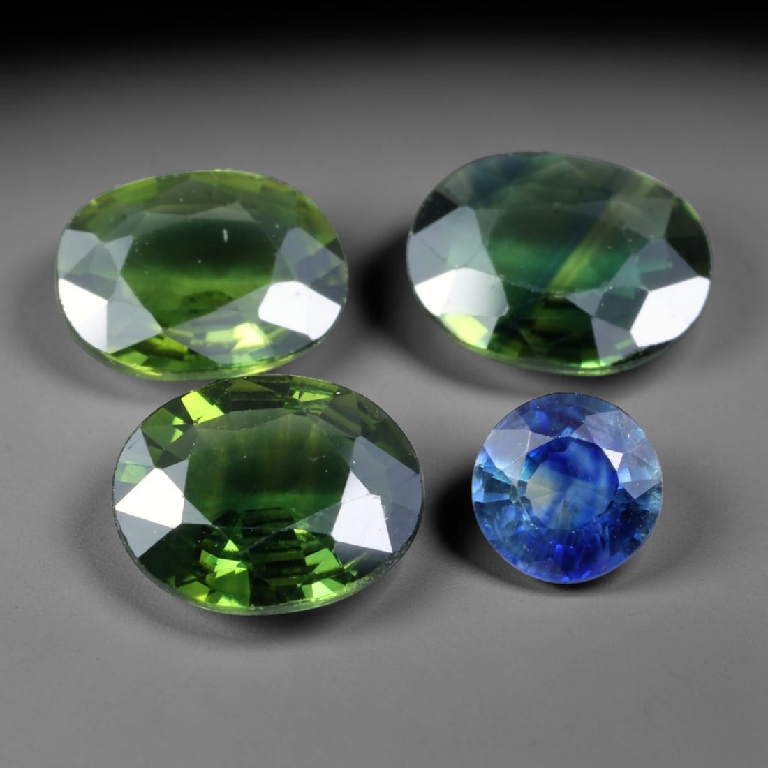 4.06ct Natural Australian Sapphire Faceted Parcel Lot, 25EX: This faceted parcel consists of mixed oval and round cut Australian sapphires, displaying striking colour variation across deep forest-green and rich royal-blue body tones. Precision faceting yields s