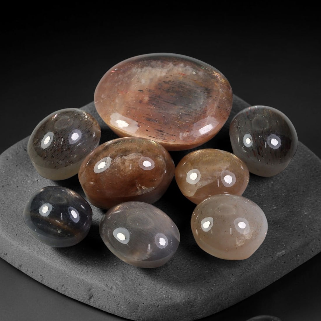 111.2ct Natural Australian Lattice Sunstone Cabochon Parcel Lot, 33EX: This polished cabochon parcel features finished Australian lattice sunstone cabochons displaying characteristic metallic hematite lattice inclusions within translucent sunstone host. The domed polishe