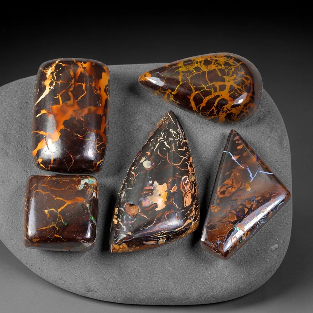 74.45ct Natural Australian Queensland Boulder Opal Cabochon Parcel Lot, 50EX: This polished cabochon parcel features six finished boulder opal cabochons with rich ironstone host matrix interlaced by vivid opal vein patterns. The cabochons display striking earthy brown-orange we