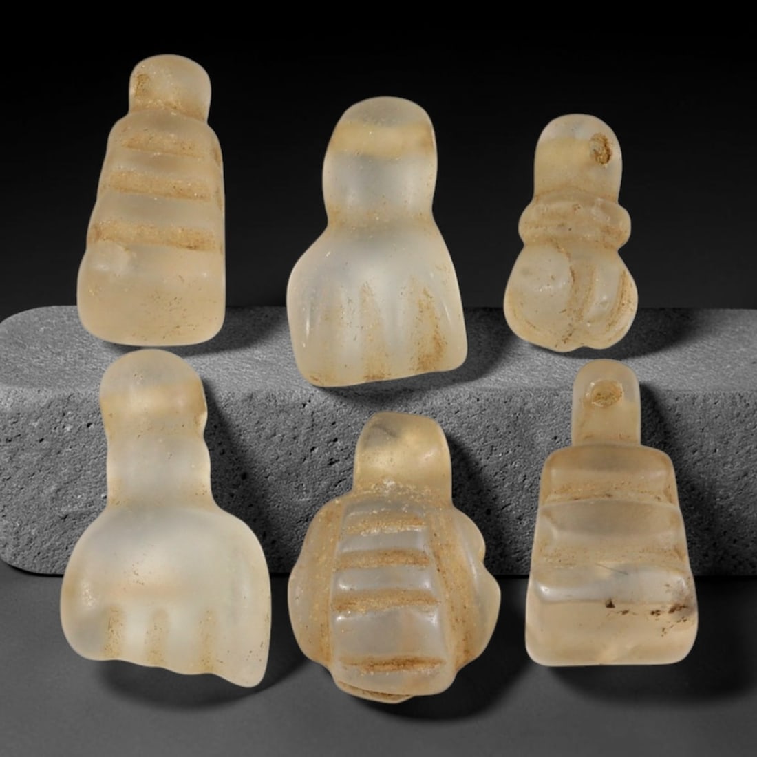 Ancient Medieval Coptic Christian Egyptian Rock Crystal Amulets Parcel Lot, 21EY: Collection of rock-crystal talismans originating from Medieval Coptic Egyptian cultural context, each formed with integral suspension lugs for wear. The group displays carved surface detailing, consis