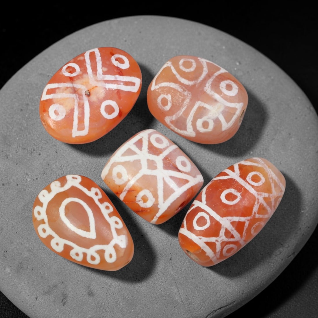 Ancient Sino-Himalayan Region Etched Carnelian Beads Parcel Lot, 13EY: Group of ancient etched carnelian beads originating from the Sino-Himalayan cultural sphere, displaying classic alkali-etch decorative motifs across translucent carnelian bodies. Each bead exhibits hi