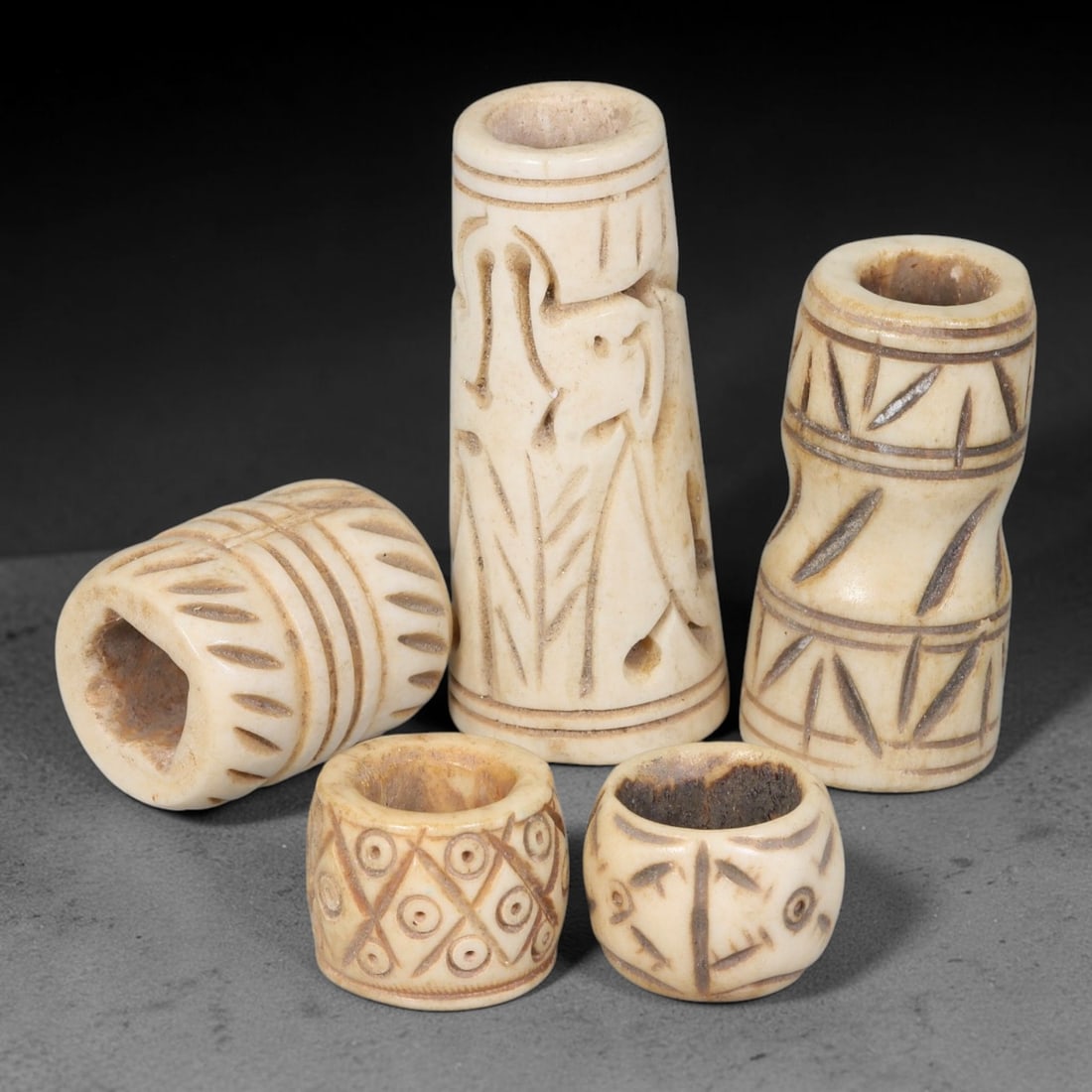 Antique Sino-Siberian Steppe Nomadic Stag Antler Carved Beads Parcel Lot, 31EY: Group of antique post-1850s Sino-Siberian steppe nomadic craft stag antler carved beads, each with fully drilled central bore for threading. Surfaces feature varied incised decorative motifs including