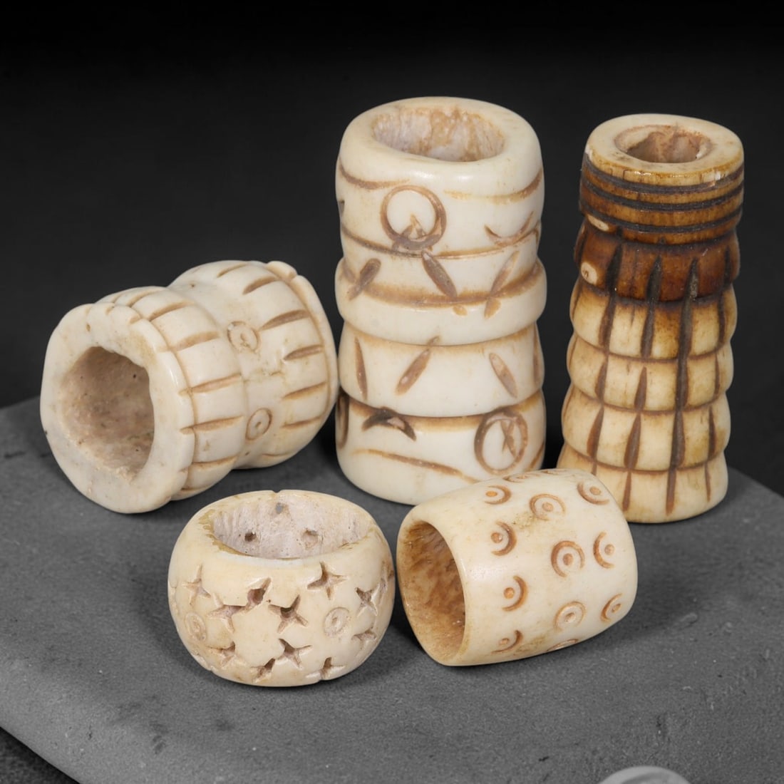 Antique Sino-Siberian Steppe Nomadic Stag Antler Carved Beads Parcel Lot, 24EY: Group of antique post-1850s Sino-Siberian steppe nomadic craft stag antler carved beads, each with fully drilled central bore for threading. Surfaces feature varied incised decorative motifs including
