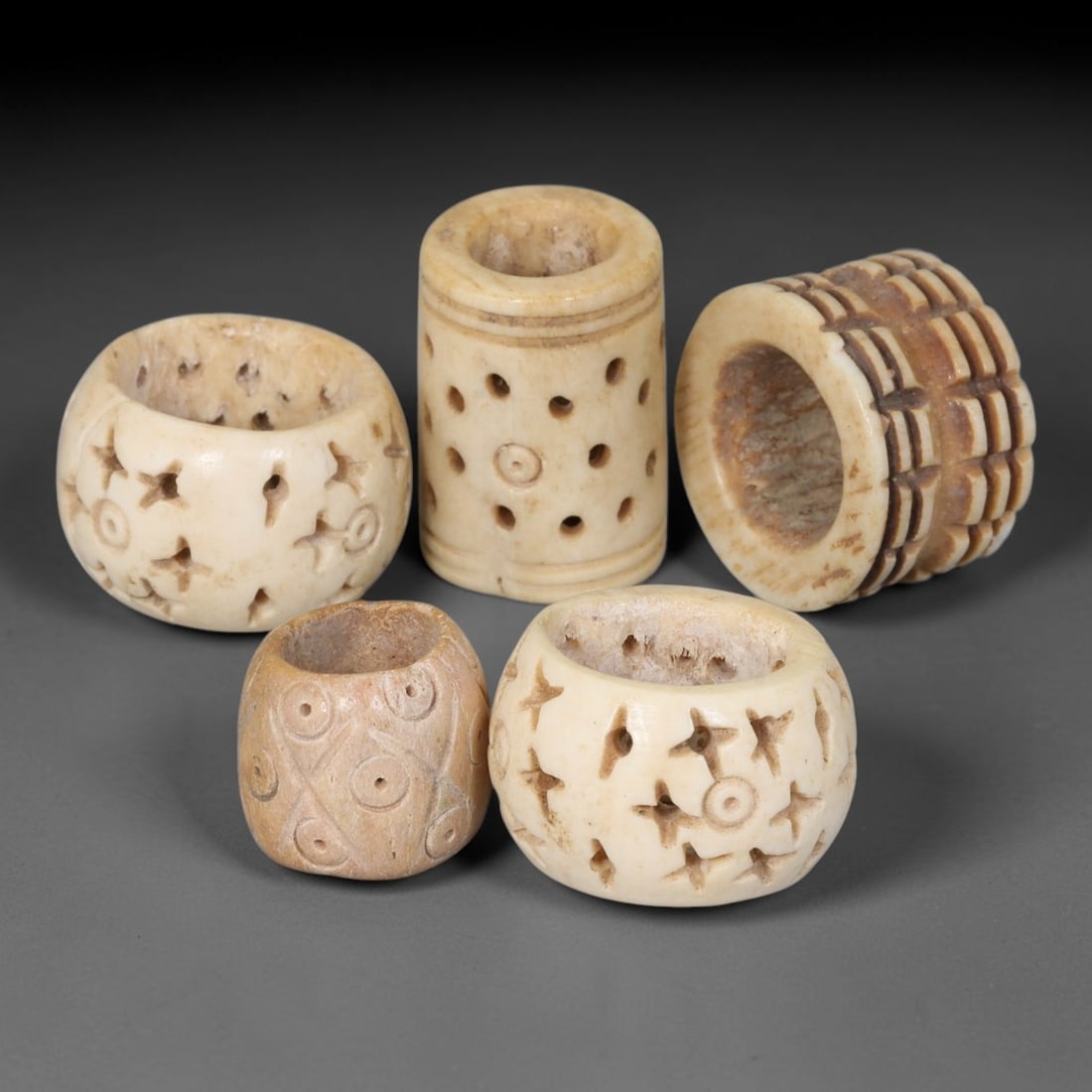 Antique Sino-Siberian Steppe Nomadic Stag Antler Carved Beads Parcel Lot, 37EY: Group of antique post-1850s Sino-Siberian steppe nomadic craft stag antler carved beads, each with fully drilled central bore for threading. Surfaces feature varied incised decorative motifs including