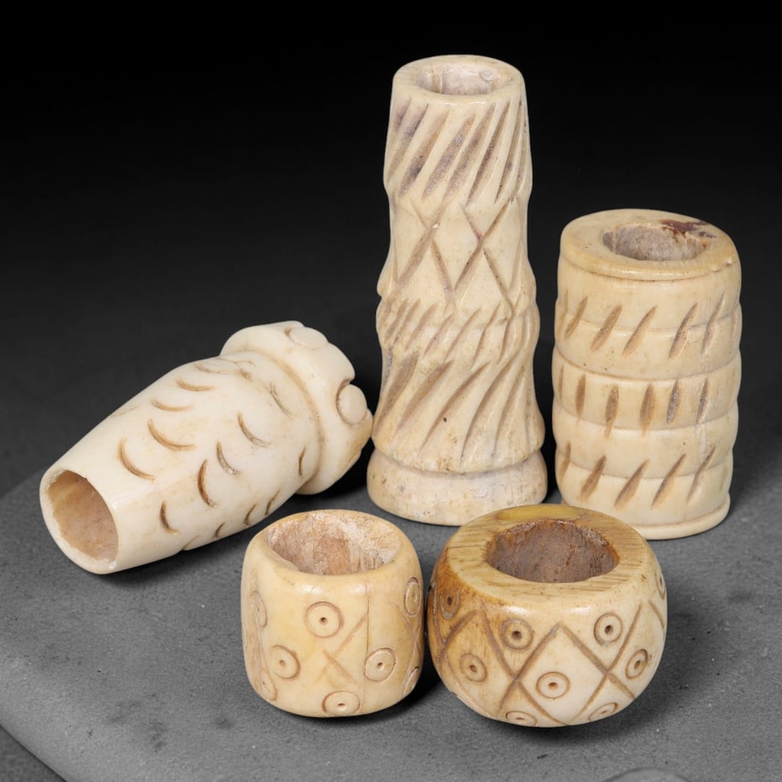 Antique Sino-Siberian Steppe Nomadic Stag Antler Carved Beads Parcel Lot, 28EY: Group of antique post-1850s Sino-Siberian steppe nomadic craft stag antler carved beads, each with fully drilled central bore for threading. Surfaces feature varied incised decorative motifs including