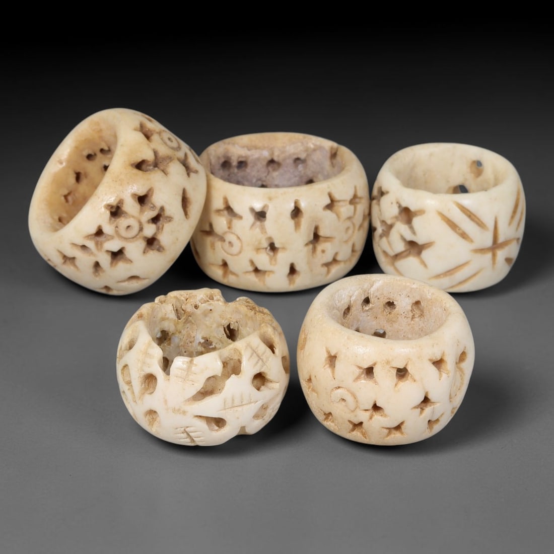 Antique Sino-Siberian Steppe Nomadic Stag Antler Carved Beads Parcel Lot, 36EY: Group of antique post-1850s Sino-Siberian steppe nomadic craft stag antler carved beads, each with fully drilled central bore for threading. Surfaces feature varied incised decorative motifs including