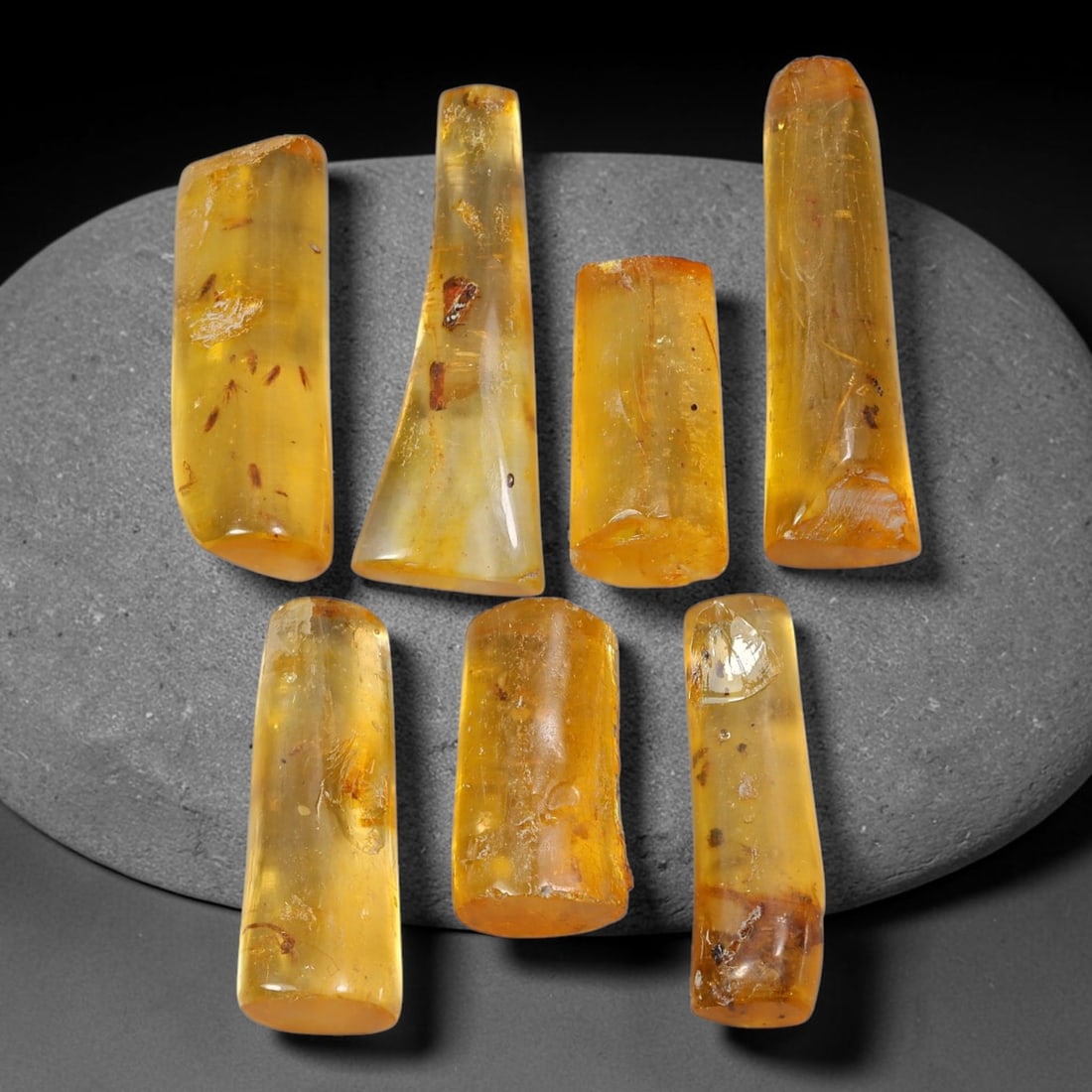 69.14ct Natural Baltic Amber Polished Rough Parcel Lot, 55EY: This polished rough parcel consists of free-form baltic amber specimens with warm golden-yellow to honey-orange translucency. Partial high-gloss polished surfaces reveal visible insect debris and orga
