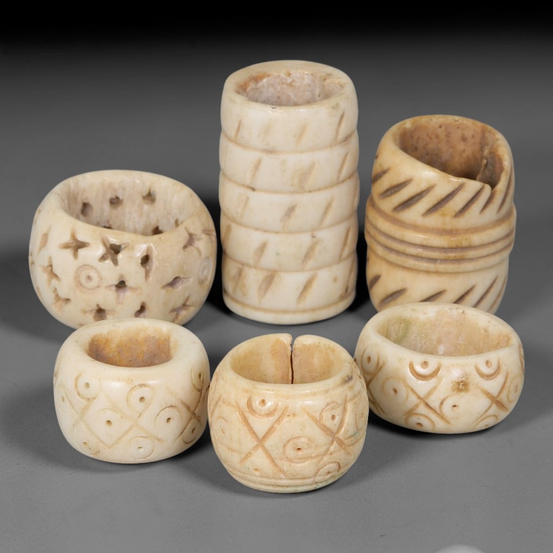 Antique Sino-Siberian Steppe Nomadic Stag Antler Carved Beads Parcel Lot, 38EY: Group of antique post-1850s Sino-Siberian steppe nomadic craft stag antler carved beads, each with fully drilled central bore for threading. Surfaces feature varied incised decorative motifs including
