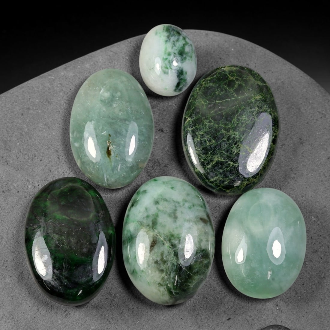 185.75ct Natural Burmese Type A Jadeite Jade Cabochon Parcel Lot, 96EY: This polished oval cabochon parcel displays natural Type A burmese jadeite jade with broad colour variation. High gloss polished domed surfaces reveal natural internal crystalline textures, mineral ve