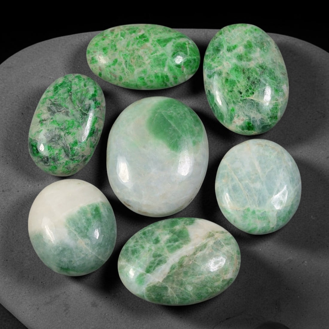 153.22ct Natural Burmese Type A Jadeite Jade Cabochon Parcel Lot, 97EY: This polished oval cabochon parcel displays natural Type A burmese jadeite jade with broad colour variation. High gloss polished domed surfaces reveal natural internal crystalline textures, mineral ve