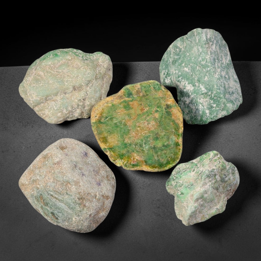 740ct Natural Burmese Type A Jadeite Jade Rough Parcel Lot, 24BC: This rough parcel includes mixed unpolished and partially sawn Type A burmese jadeite jade chunks. Specimens exhibit varied visual features including bright patchy green mottling, pale celadon-green, 