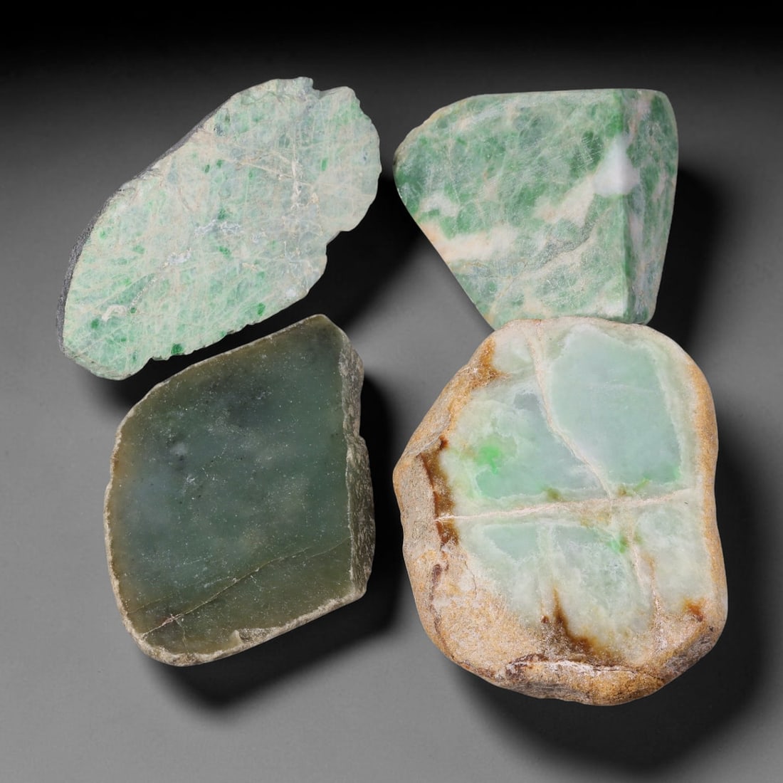 1185ct Natural Burmese Type A Jadeite Jade Rough Parcel Lot, 20BC: This rough parcel includes mixed unpolished and partially sawn Type A burmese jadeite jade chunks. Specimens exhibit varied visual features including bright patchy green mottling, pale celadon-green, 