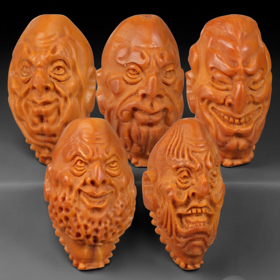 Chinese Carved Natural Olive Nut Drilled Art Bead Parcel Lot, 35BC: Set of Chinese natural olive nut carved beads, each deeply sculpted with expressive facial forms and fully centre-drilled for threading. Warm natural aged nut patina and fine surface carving detail th