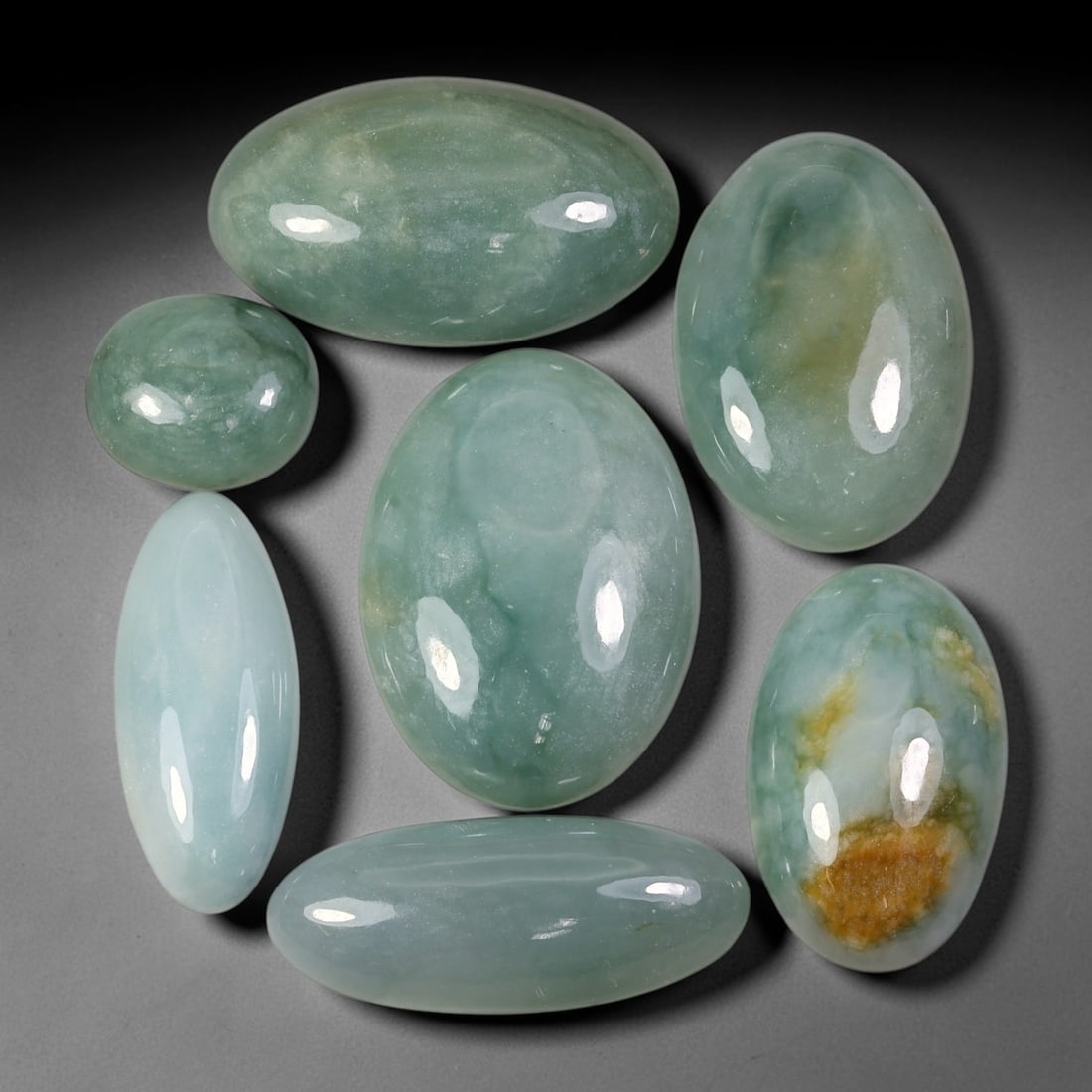 268.80ct Natural Burmese Type A Jadeite Jade Cabochon Parcel Lot, 2BC: This polished oval cabochon parcel displays natural Type A burmese jadeite jade with broad colour variation. High gloss polished domed surfaces reveal natural internal crystalline textures, mineral ve
