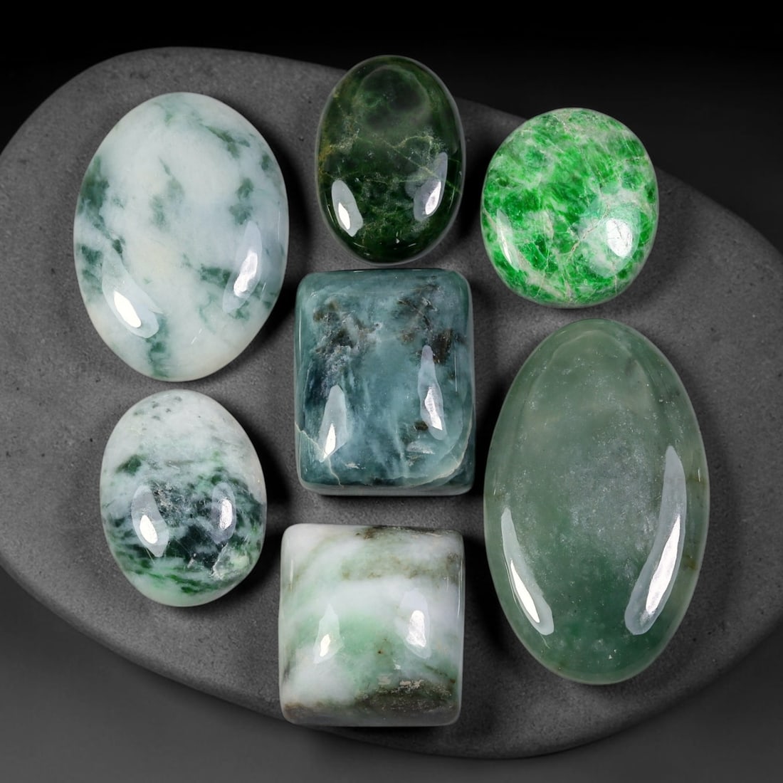 198.43ct Natural Burmese Type A Jadeite Jade Cabochon Parcel Lot, 1BC: This polished oval cabochon parcel displays natural Type A burmese jadeite jade with broad colour variation. High gloss polished domed surfaces reveal natural internal crystalline textures, mineral ve