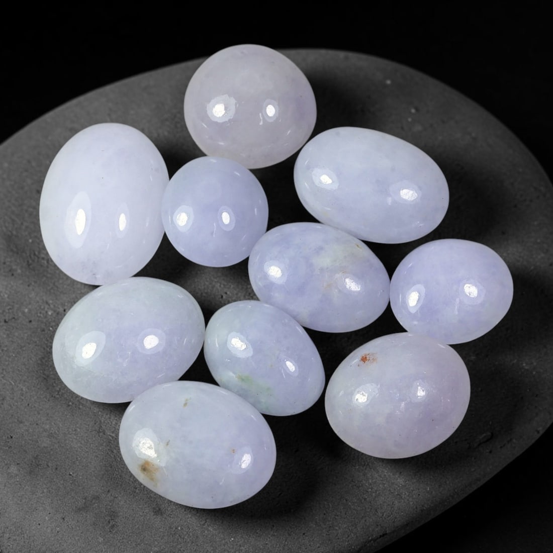 55.93ct Natural Burmese Type A Lavender Jadeite Jade Cabochon Parcel Lot, 35EX: This polished cabochon parcel features oval and round cabochon Type A jadeite jade displaying soft lavender-lilac body tones across the set. Smooth high-gloss domed surfaces showcase gentle colour var