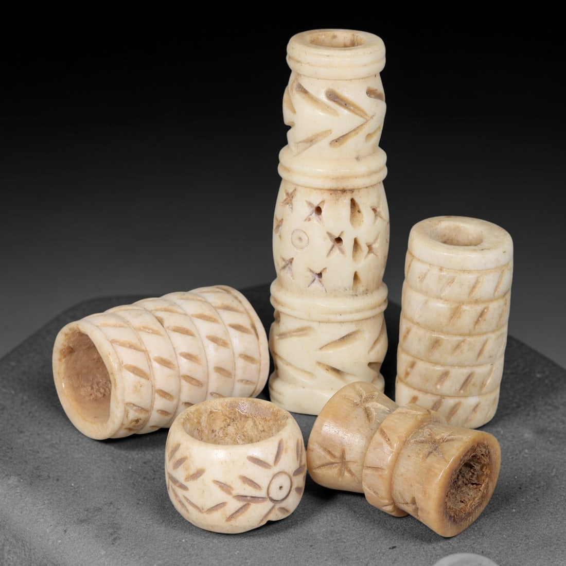 Antique Sino-Siberian Steppe Nomadic Stag Antler Carved Beads Parcel Lot, 30EY: Group of antique post-1850s Sino-Siberian steppe nomadic craft stag antler carved beads, each with fully drilled central bore for threading. Surfaces feature varied incised decorative motifs including