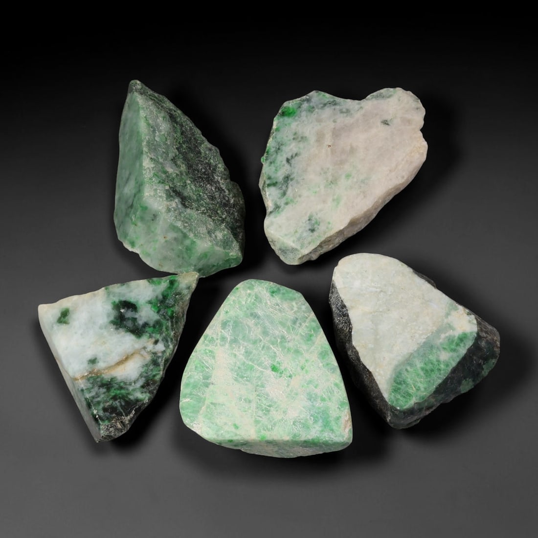 820ct Natural Burmese Type A Jadeite Jade Rough Parcel Lot, 25BC: This rough parcel includes mixed unpolished and partially sawn Type A burmese jadeite jade chunks. Specimens exhibit varied visual features including bright patchy green mottling, pale celadon-green, 
