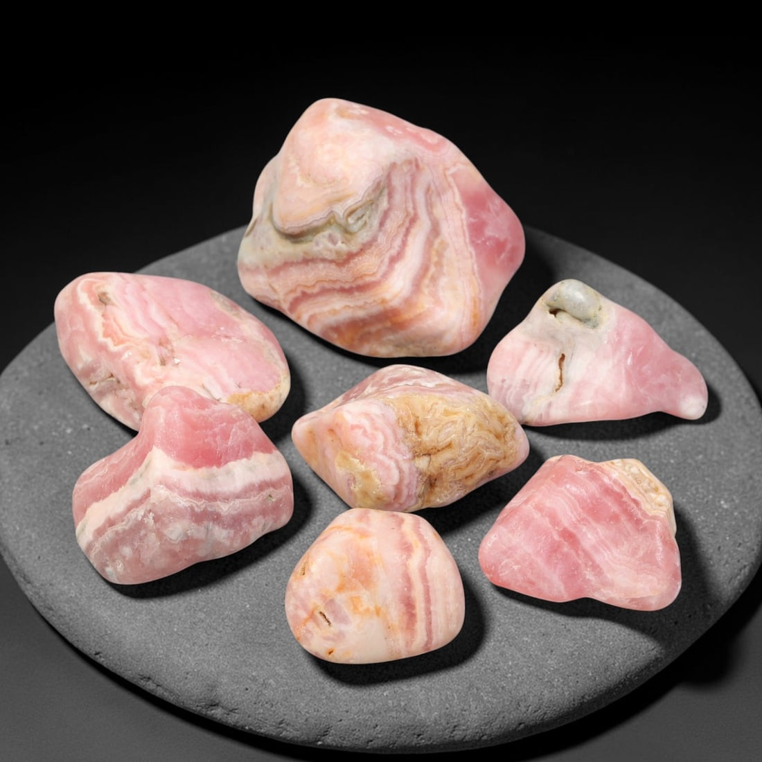 189ct Natural Argentinian Rhodochrosite Tumbled Rough Parcel Lot, 2EW: This beautiful parcel of tumbled rhodochrosite rough showcases striking banded patterning of rich rose-pink, creamy white and subtle earth-toned mineral layers across smooth free-form tumbled surfaces