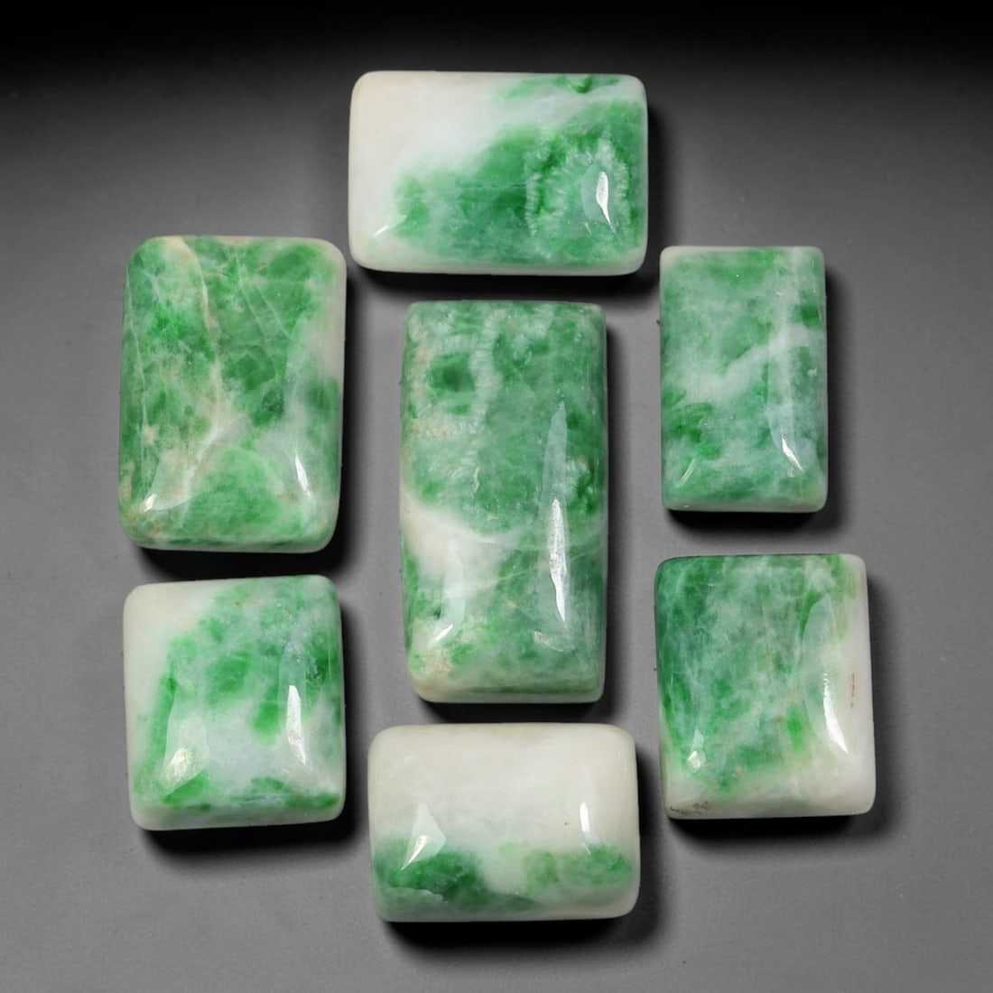 156.41ct Natural Burmese Type A Jadeite Jade Cabochon Parcel Lot, 3BC: This polished oval cabochon parcel displays natural Type A burmese jadeite jade with broad colour variation. High gloss polished domed surfaces reveal natural internal crystalline textures, mineral ve