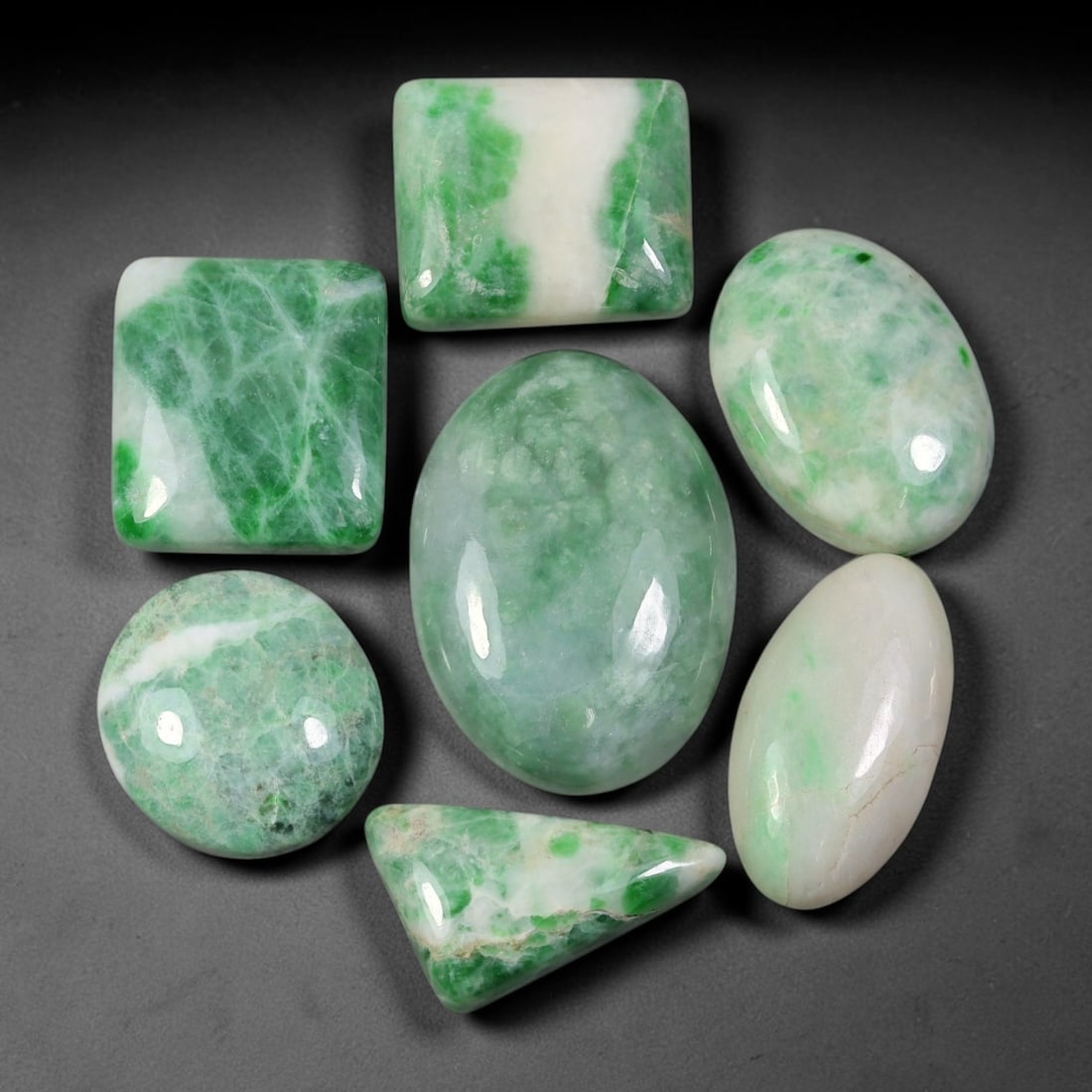 154.97ct Natural Burmese Type A Jadeite Jade Cabochon Parcel Lot, 98EY: This polished oval cabochon parcel displays natural Type A burmese jadeite jade with broad colour variation. High gloss polished domed surfaces reveal natural internal crystalline textures, mineral ve