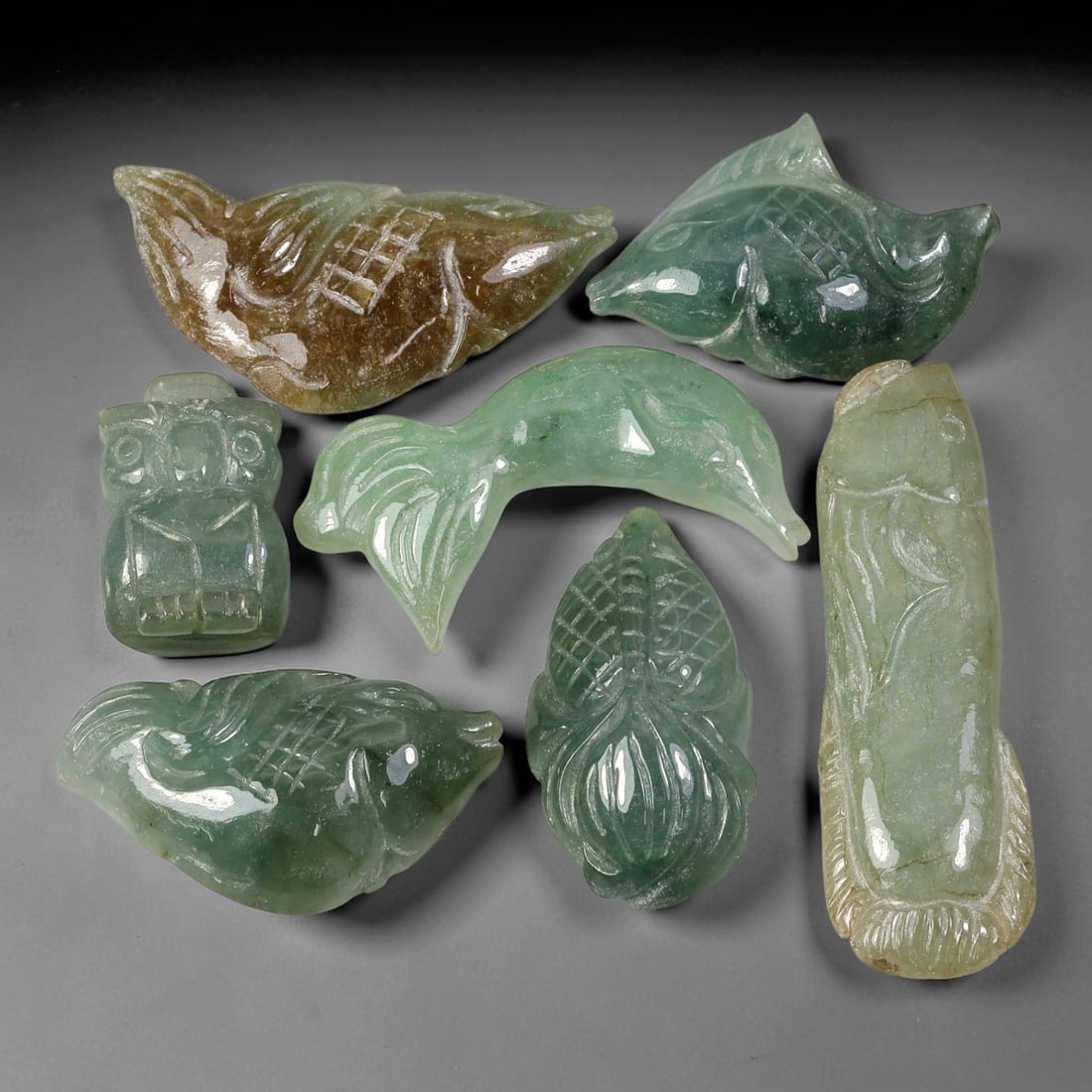 175.87ct Natural Burmese Type A Jadeite Jade Carving Pendant Parcel Lot, 86EX: This parcel lot consists of hand-carved Type A jadeite pendants displaying varied natural colour tones including deep forest green, soft pale green, and warm yellow-gold hues. Each piece finished with