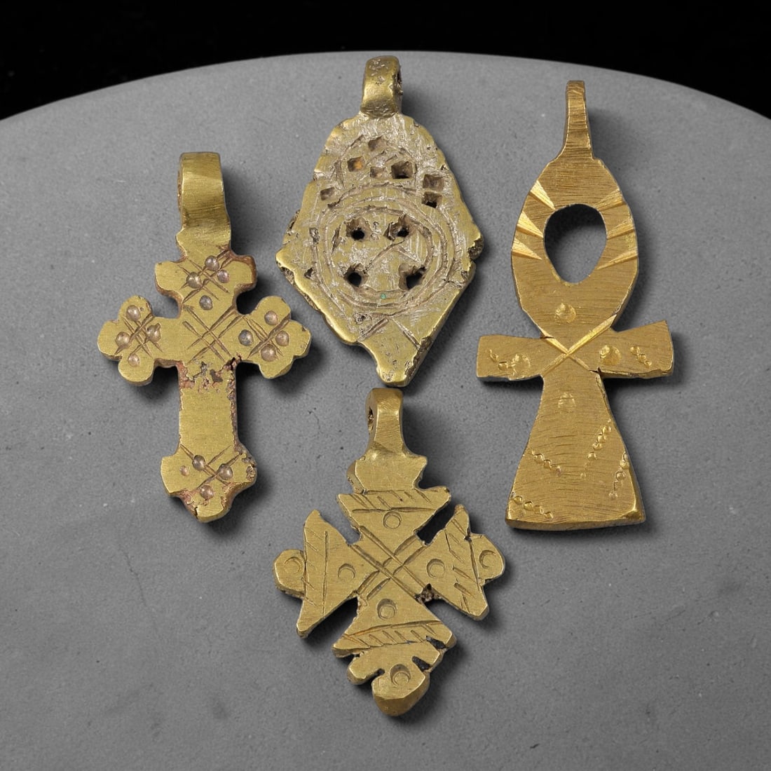Vintage Coptic Ethiopian Christian Copper Alloy Cross Pendants Parcel Lot, 40BC: Group of vintage Coptic Ethiopian Christian pendants crafted from copper alloy, featuring varied cross-form silhouettes with hand-incised surface ornamentation and integrated suspension loops for wear