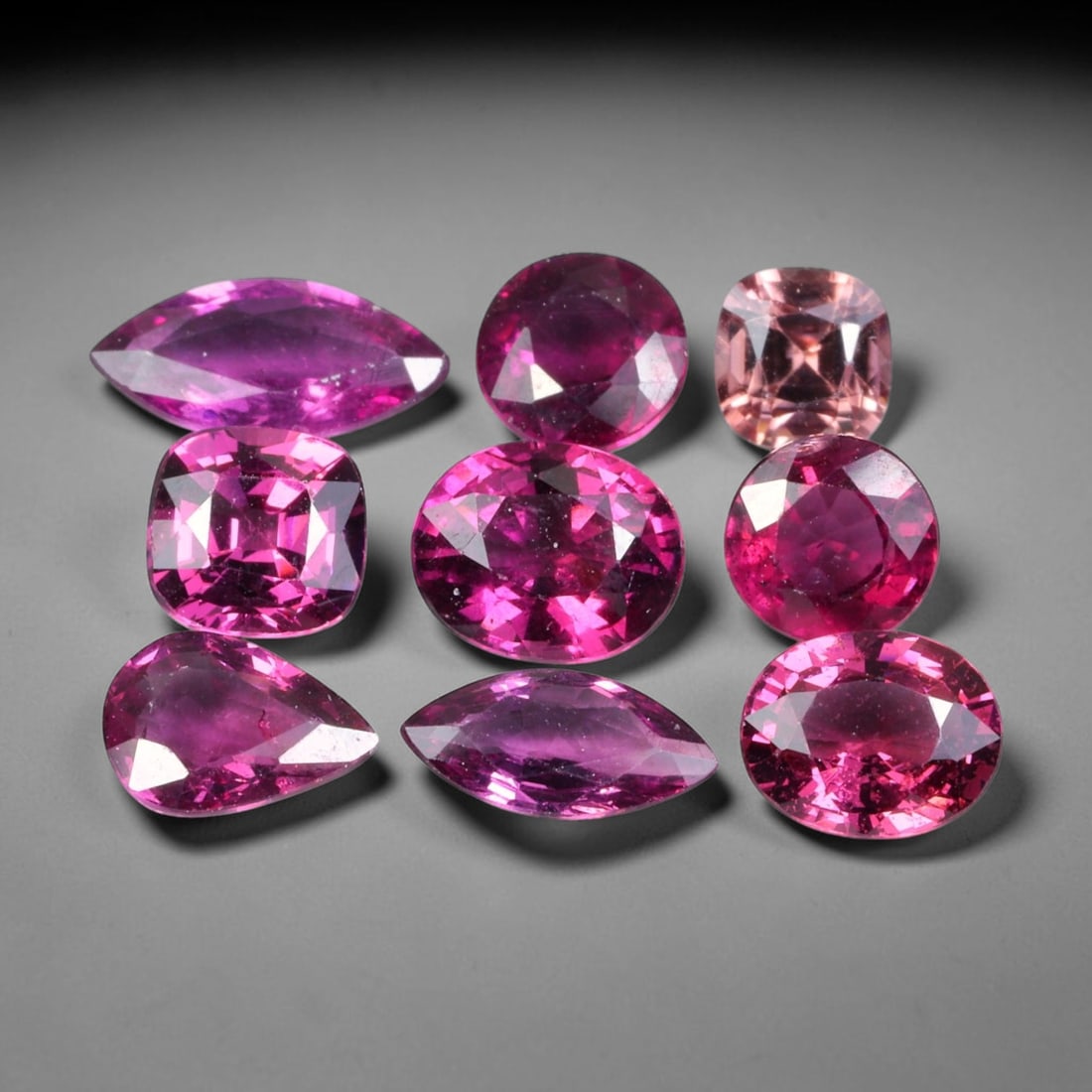 8.36ct Natural Mozambican Raspberry Pink Rhodolite Garnet Loose Gemstone Parcel Lot, 84EV: This dazzling parcel of rhodolite garnet displays rich raspberry-pink and deep magenta tones, brought alive by sharp faceting that delivers vivid sparkle across cushion, oval and pear shapes. Vibrant 