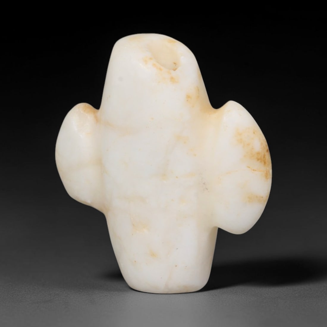Early Islamic Abbasid White Calcite Ceremonial Axe Amulet (c.750-950 CE), 99EQ: Hand-carved from pale white calcite stone originating from the Abbasid Caliphate realm of the Near East and Iranian plateau. This miniature wearable talisman is fashioned into a stylised ceremonial ax