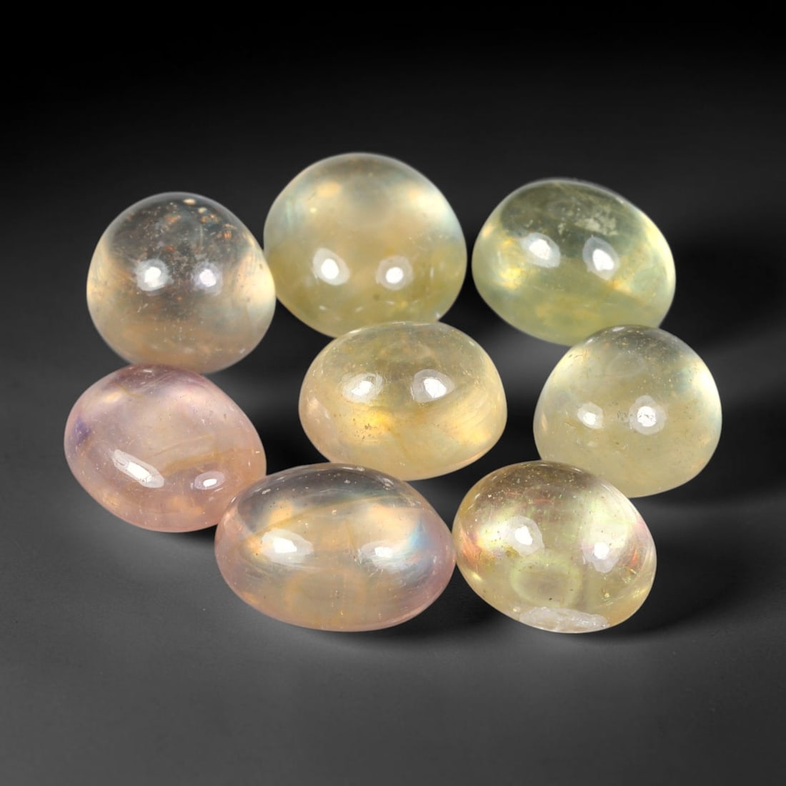 23.53ct Natural Sri Lankan Multi-Tone Sapphire Cabochon Loose Gemstone Parcel Lot, 24EV: This lovely parcel of sapphire cabochons features soft blended tones of pale yellow, champagne and subtle blush pink across smooth polished oval domed surfaces. Gentle iridescent internal reflections 