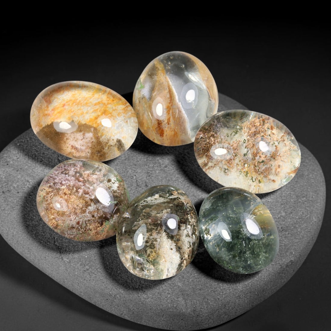 205.55ct Natural Brazilian Phantom Quartz Cabochon Parcel Lot, 67EW: This polished cabochon parcel of natural phantom quartz features transparent clear quartz host stone enclosing intricate internal phantom mineral deposits. Each oval cabochon displays unique scenic in