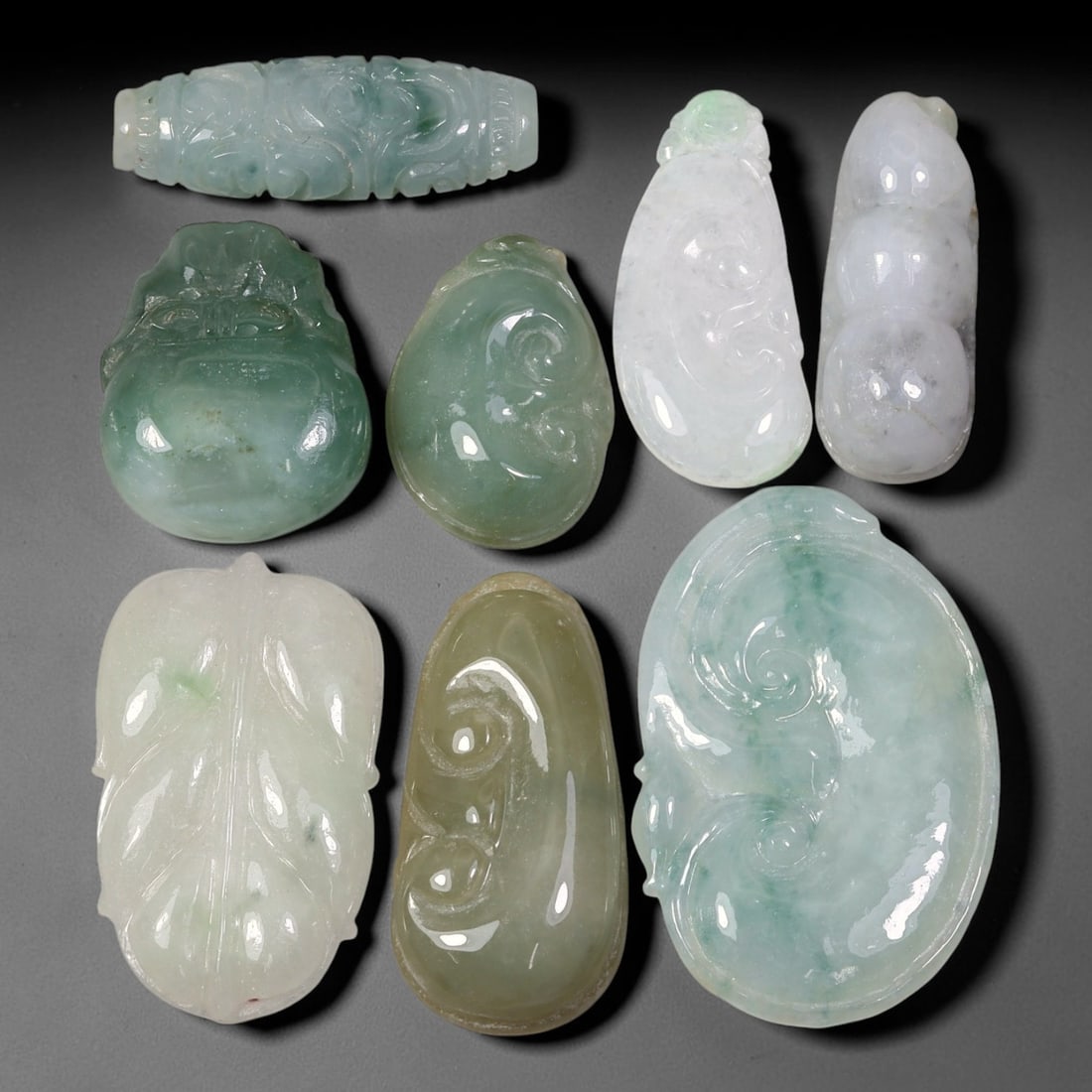 231.72ct Natural Burmese Type A Jadeite Jade Carving Pendant Parcel Lot, 93EX: This parcel lot consists of hand-carved Type A jadeite pendants displaying varied natural colour tones including deep forest green, soft pale green, and warm yellow-gold hues. Each piece finished with