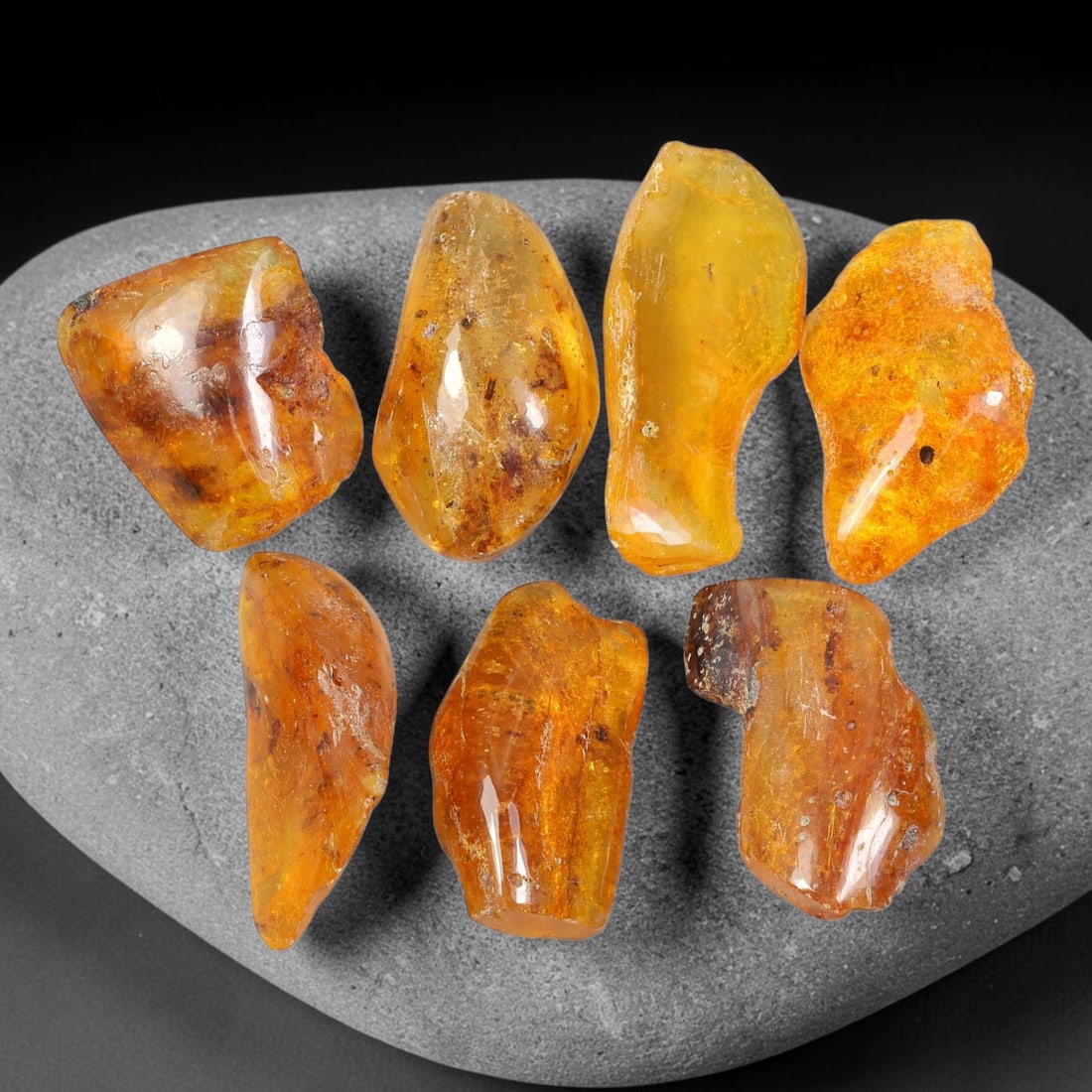 110.03ct Natural Baltic Amber Polished Rough Parcel Lot, 48EY: This polished rough parcel consists of free-form baltic amber specimens with warm golden-yellow to honey-orange translucency. Partial high-gloss polished surfaces reveal visible insect debris and orga