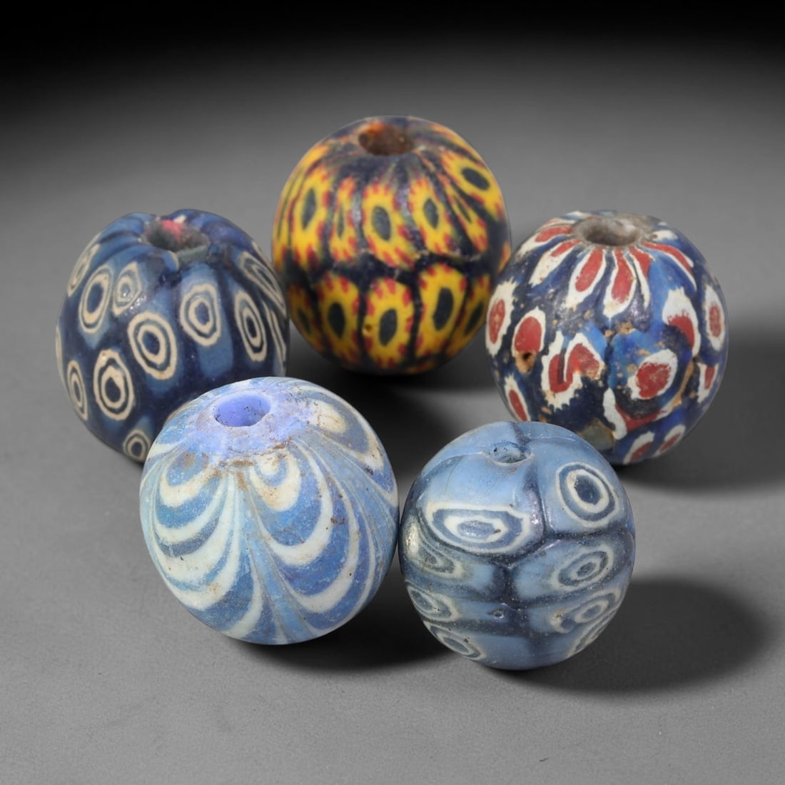 Antique Borneo Millefiori Glass Trade Beads Parcel Lot, 18BC: Collection of historic Borneo millefiori glass trade beads, displaying complex composite cane-work patterns across each spherical specimen. These antique trade examples exhibit age-related surface wea
