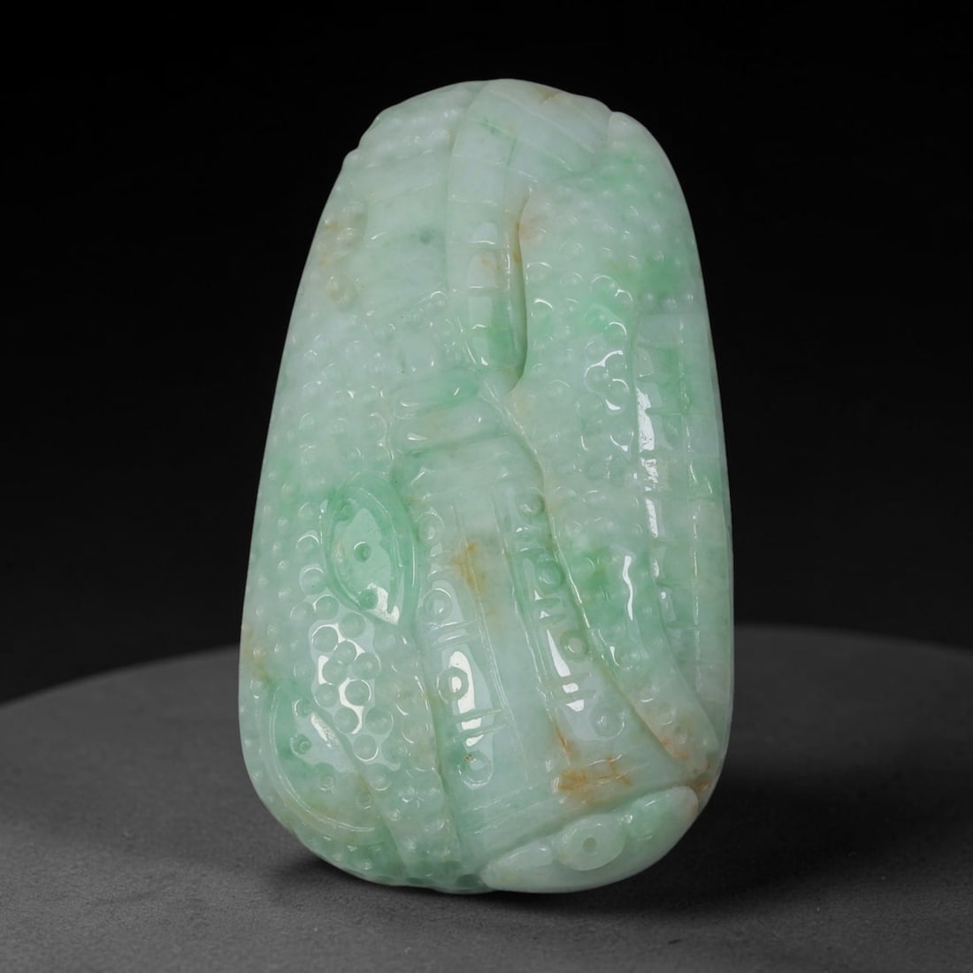 Natural Burmese Type A Jadeite Jade Carved Pendant, 37AG: This substantial free-form pendant is carved from natural Burmese Type A jadeite jade, exhibiting soft pale base colour accented by vibrant patches of natural green colouration alongside subtle russet