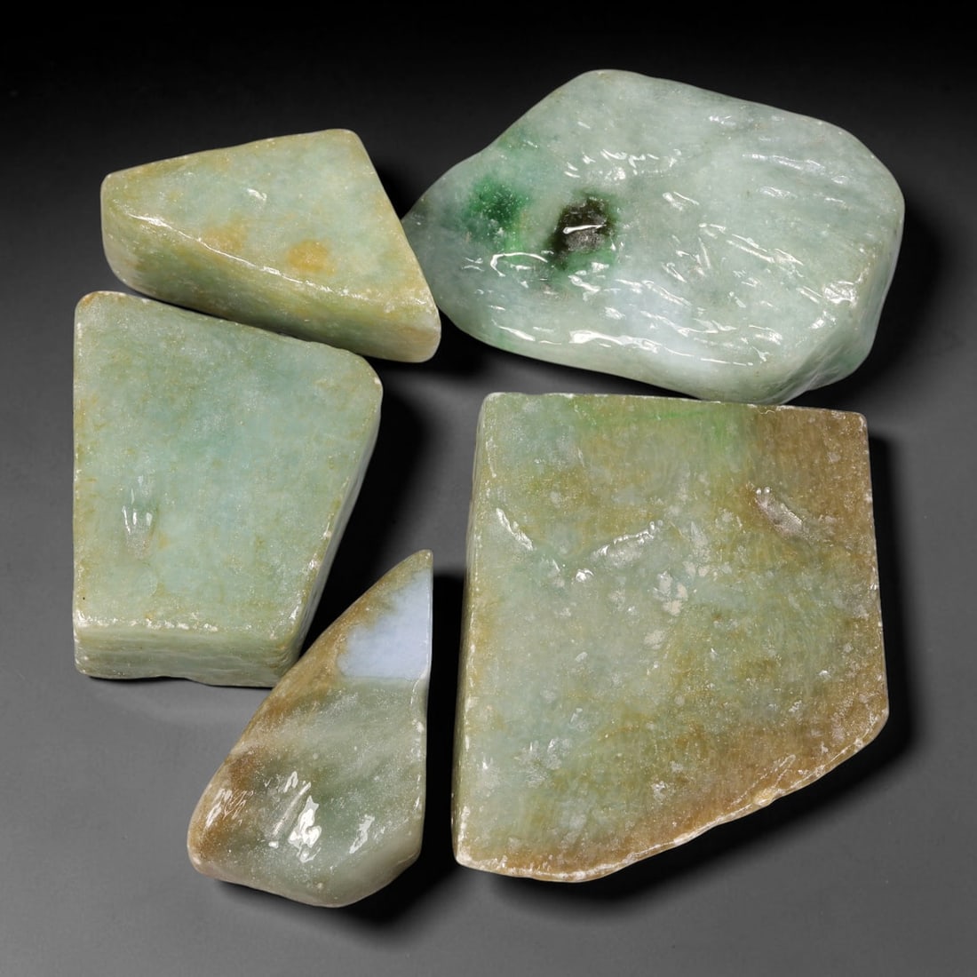 560ct Natural Burmese Type A Jadeite Jade Fully Polished Rough Parcel Lot, 22BC: This parcel features fully polished rough slabs of authentic Type A burmese jadeite jade, presenting mixed colour profiles including soft pale celadon-green, scattered vivid green patches, creamy whit