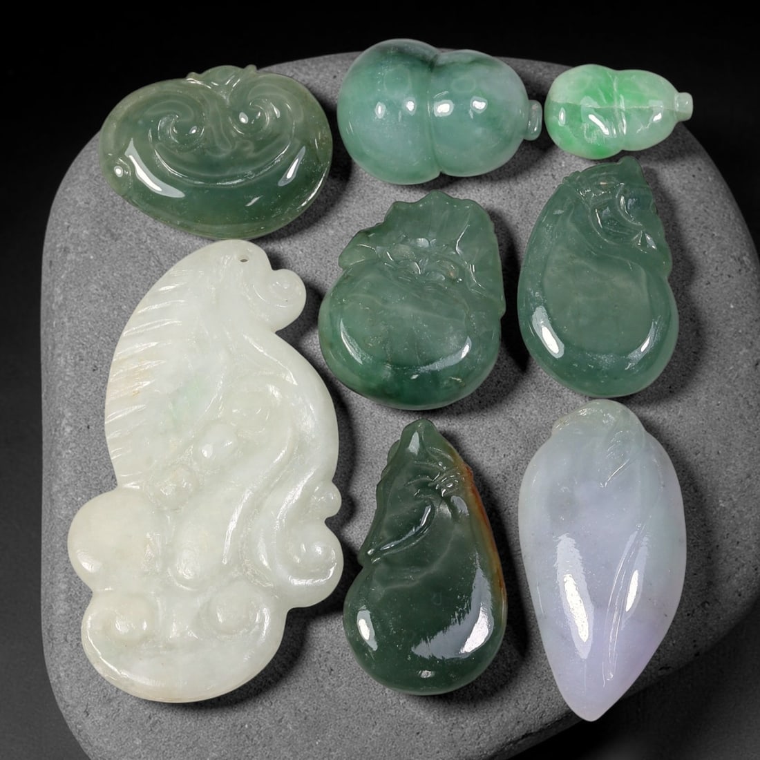 200.55ct Natural Burmese Type A Jadeite Jade Carving Pendant Parcel Lot, 92EX: This parcel lot consists of hand-carved Type A jadeite pendants displaying varied natural colour tones including deep forest green, soft pale green, and warm yellow-gold hues. Each piece finished with