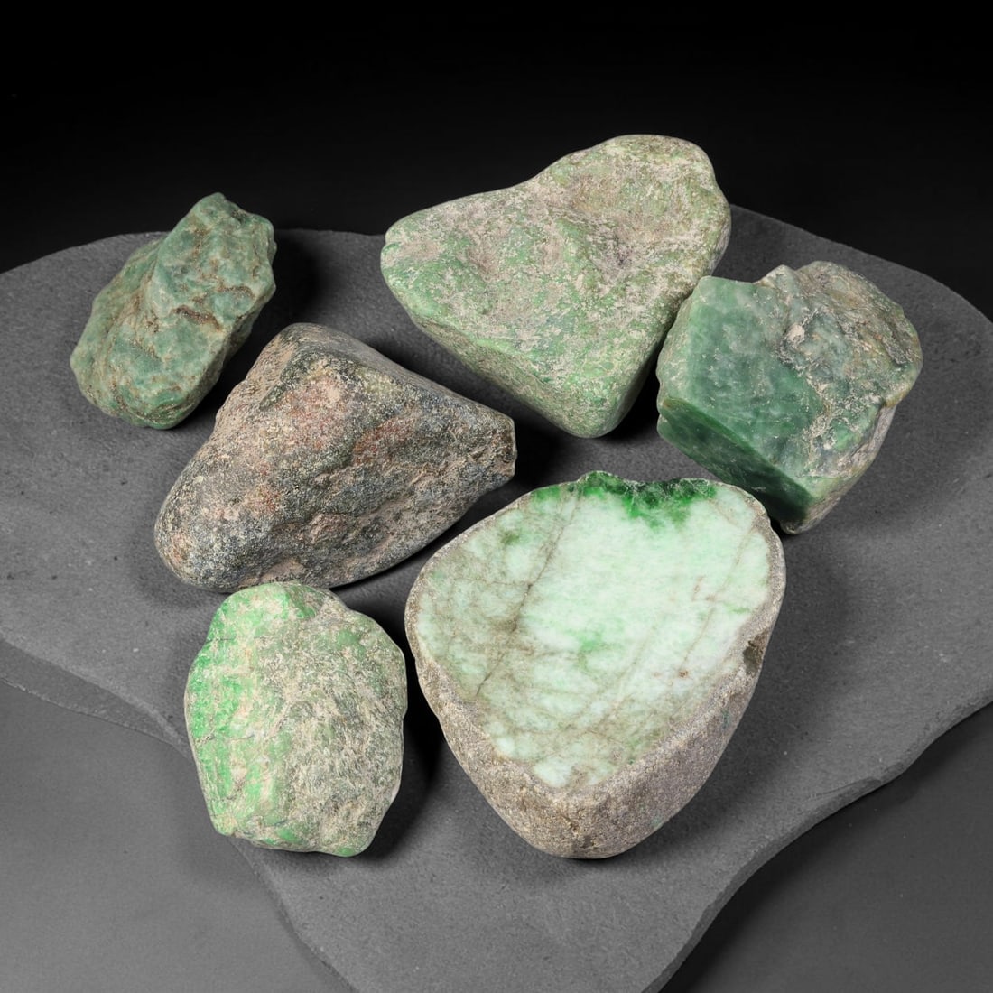 1075ct Natural Burmese Type A Jadeite Jade Rough Parcel Lot, 23BC: This rough parcel includes mixed unpolished and partially sawn Type A burmese jadeite jade chunks. Specimens exhibit varied visual features including bright patchy green mottling, pale celadon-green, 