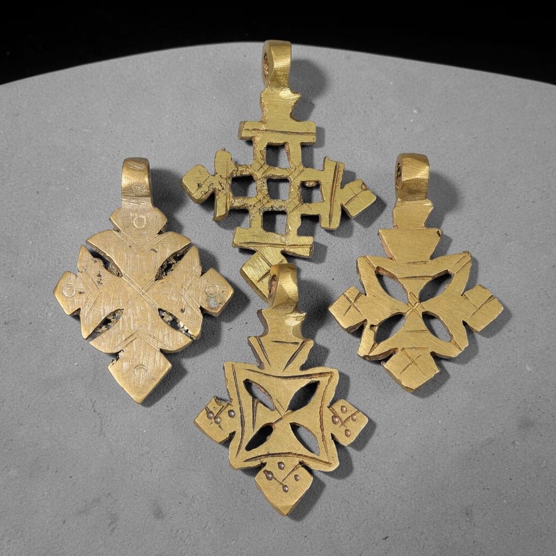 Vintage Coptic Ethiopian Christian Copper Alloy Cross Pendants Parcel Lot, 41BC: Group of vintage Coptic Ethiopian Christian pendants crafted from copper alloy, featuring varied cross-form silhouettes with hand-incised surface ornamentation and integrated suspension loops for wear