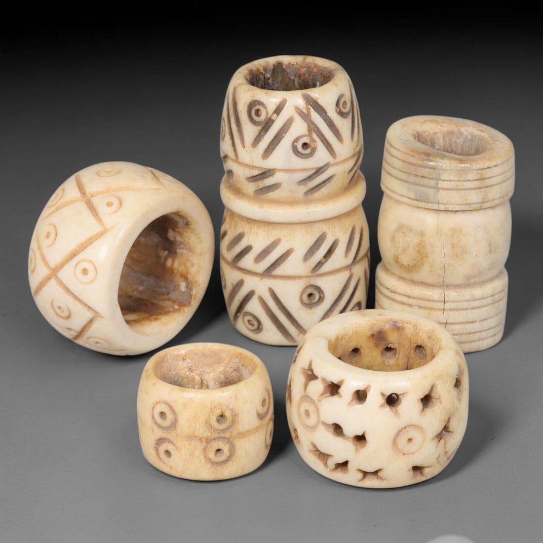 Antique Sino-Siberian Steppe Nomadic Stag Antler Carved Beads Parcel Lot, 25EY: Group of antique post-1850s Sino-Siberian steppe nomadic craft stag antler carved beads, each with fully drilled central bore for threading. Surfaces feature varied incised decorative motifs including
