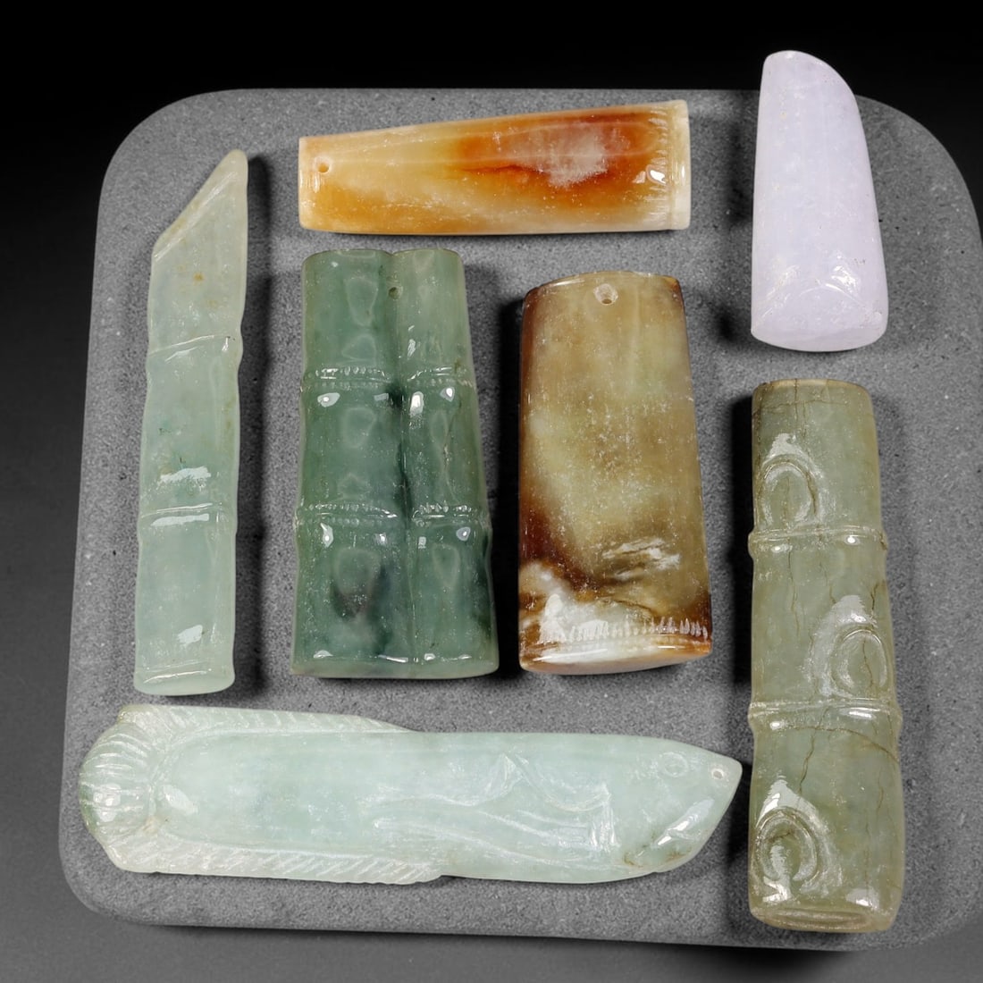 178.44ct Natural Burmese Type A Jadeite Jade Carving Pendant Parcel Lot, 84EX: This parcel lot consists of hand-carved Type A jadeite pendants displaying varied natural colour tones including deep forest green, soft pale green, and warm yellow-gold hues. Each piece finished with