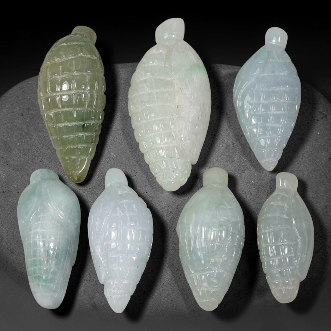 230.75ct Natural Burmese Type A Jadeite Jade Carving Pendant Parcel Lot, 83EX: This parcel lot consists of hand-carved Type A jadeite pendants displaying varied natural colour tones including deep forest green, soft pale green, and warm yellow-gold hues. Each piece finished with