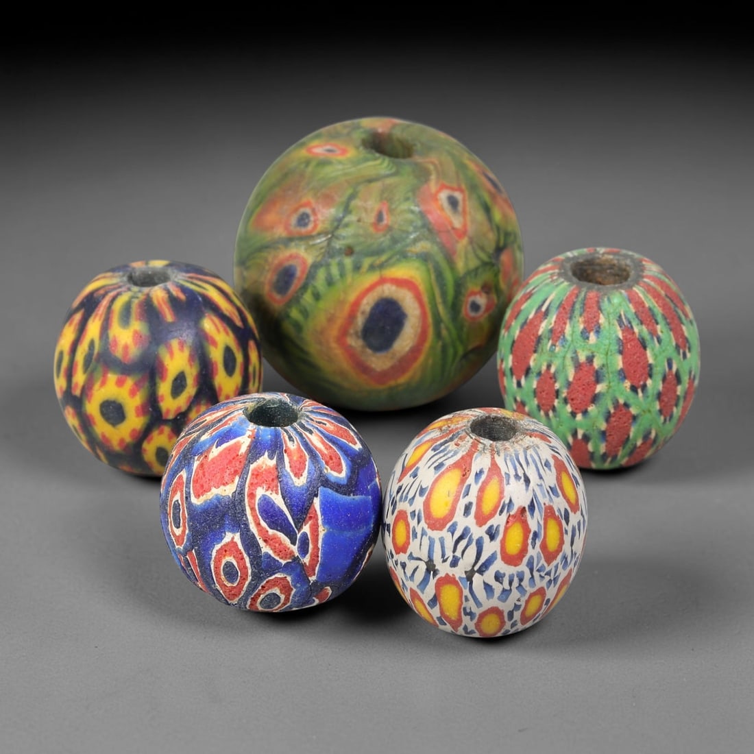 Antique Borneo Millefiori Glass Trade Beads Parcel Lot, 16BC: Collection of historic Borneo millefiori glass trade beads, displaying complex composite cane-work patterns across each spherical specimen. These antique trade examples exhibit age-related surface wea