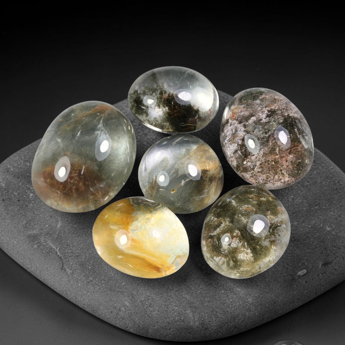 172.27ct Natural Brazilian Phantom Quartz Cabochon Parcel Lot, 65EW: This polished cabochon parcel of natural phantom quartz features transparent clear quartz host stone enclosing intricate internal phantom mineral deposits. Each oval cabochon displays unique scenic in