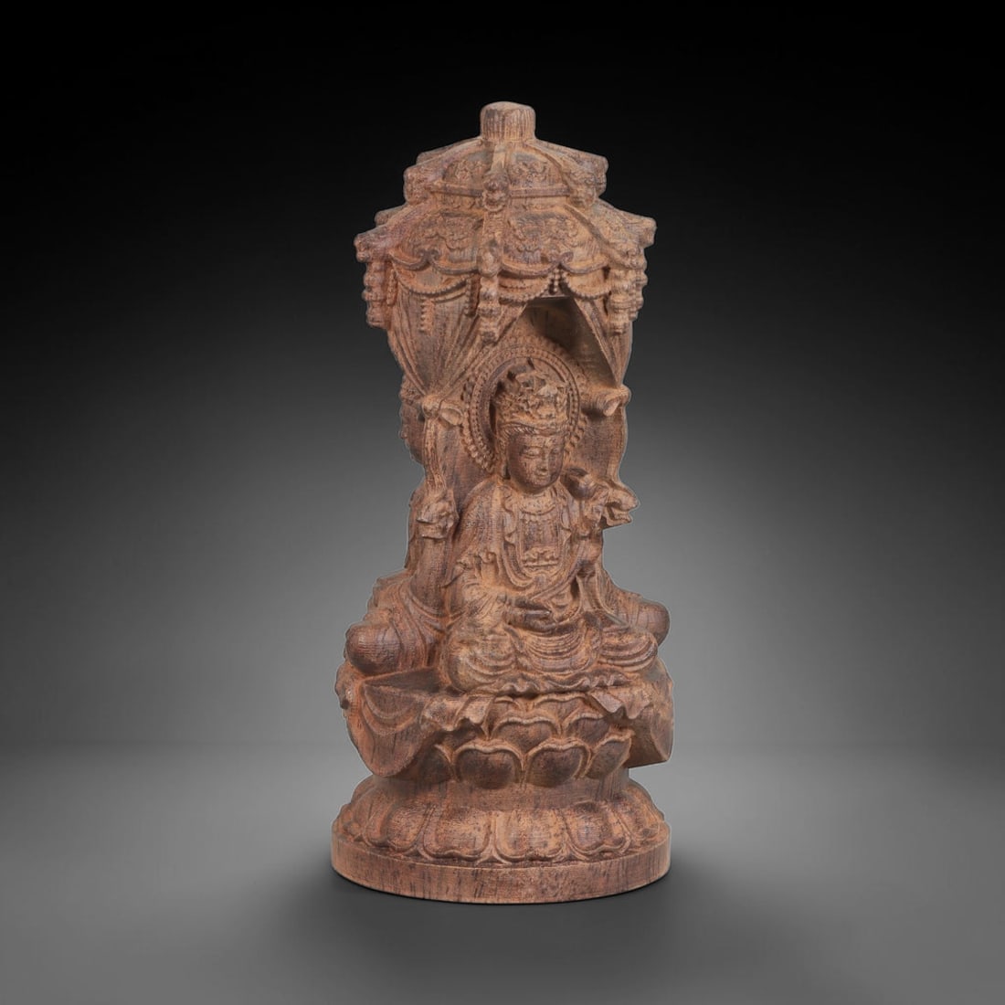 A Carved Agarwood Group of Three Buddhist Deities Sculpture, 10AD: Carved from a single block of fragrant agarwood (Aquilaria spp.), the group comprises three Buddhist deities in a unified composition. The central figure is a seated Shakyamuni Buddha in a meditative 