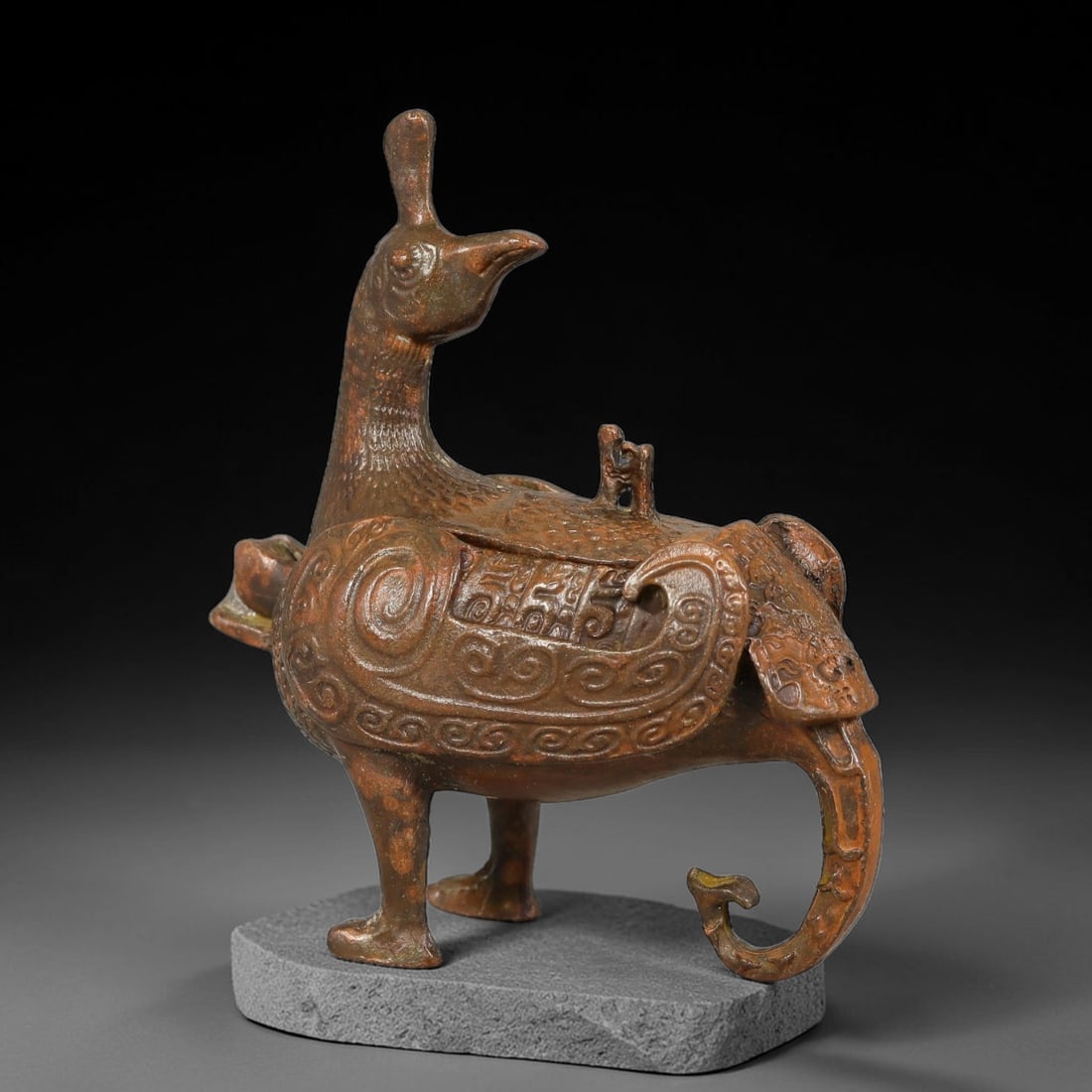 A Chinese Bronze Phoenix-Form Lidded Censer, 20AD: Cast in bronze, this figural censer is modelled as an elegant phoenix standing upon sturdy detailed legs, with raised crest and gracefully curved neck. The removable lidded compartment sits atop its b