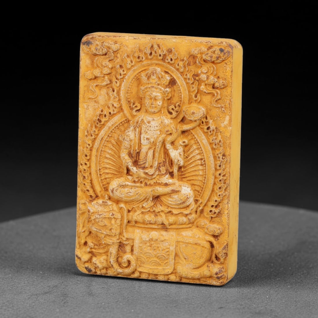 A Chinese Samantabhadra Deity Carved Tagua Nut Pendant Amulet, 99BC: Carved from tagua nut, also known as ivory nut or vegetable ivory, the rectangular pendant is decorated on both faces. The obverse depicts Samantabhadra seated upon a six-tusked white elephant, surrou